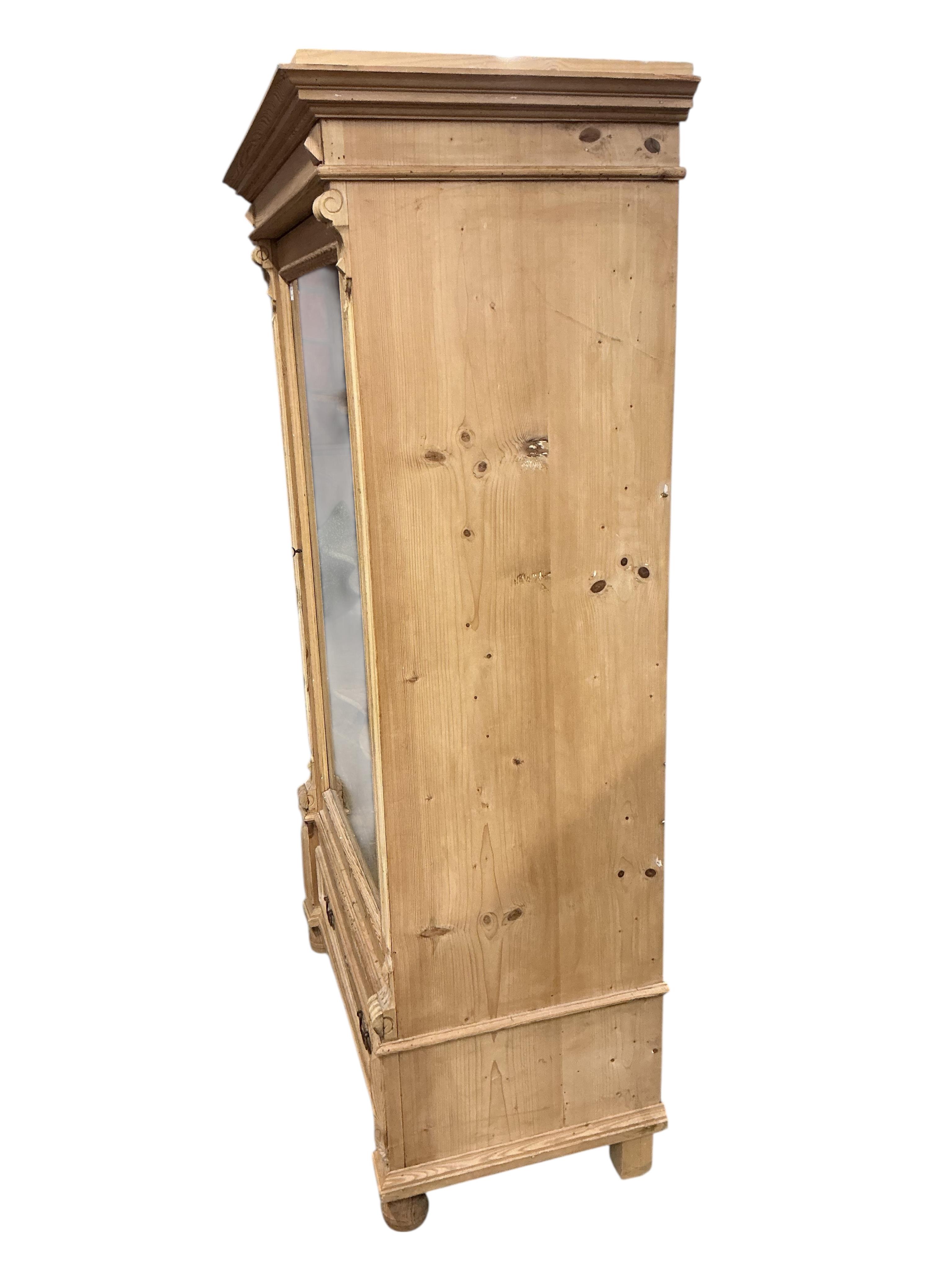 A 19th century East European glazed pine armoire, width 105cm, depth 56cm, height 182cm